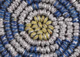 flattened soda cans arranged in a spiral