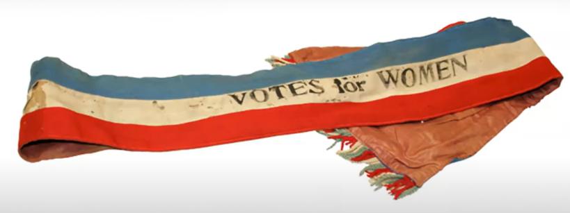 election sash with 'votes for women' imprinted on it