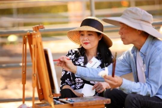 man and woman painting during plein air