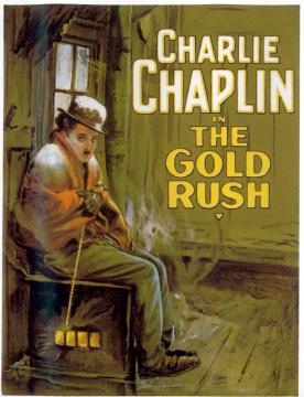A vintage movie poster shows Charlie Chaplin sitting by a stove in a rustic cabin, dressed in a coat, bowler hat, and boots. Large yellow text reads, "Charlie Chaplin in The Gold Rush.