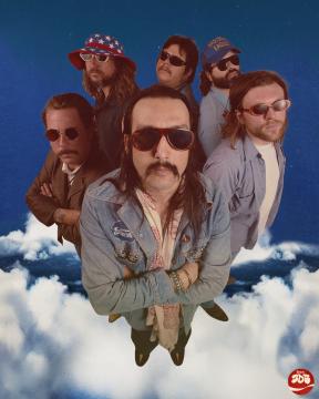 Six men wearing sunglasses and retro clothing stand closely together above clouds, with a vivid blue sky background. Two wear hats, and all have facial hair and distinctive style, conveying a vintage, rock band vibe.