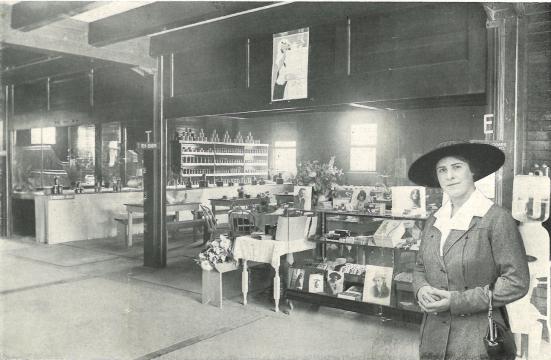 woman stands in front of shop