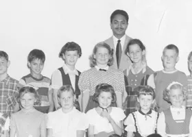 black and white school class picture with Mervyn M. Dymally as teacher standing behind his students