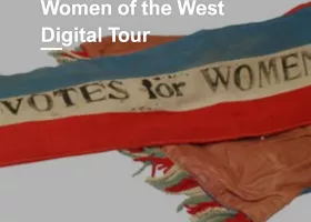 red, white, and blue banner with text saying "VOTES FOR WOMEN"