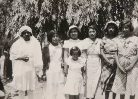 black and white photograph of Native American girls wearing light-colored dresses