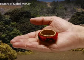 hand holds miniature feathered basket