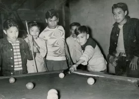 students relaxing by paying pool