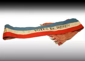 election sash with 'votes for women' imprinted on it