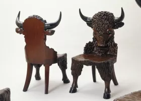 Two Wood Chairs with Carved Buffalo Backs