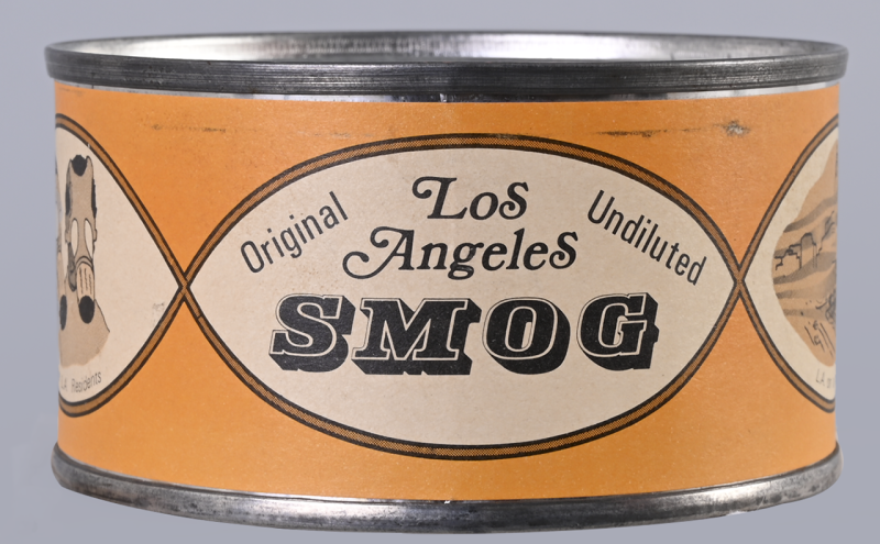 A cylindrical tin can labeled "Los Angeles Original Undiluted SMOG" with vintage-style graphics and an orange background.