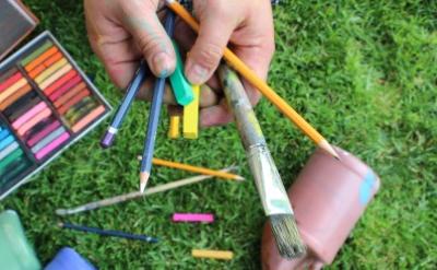 hands holding art supplies