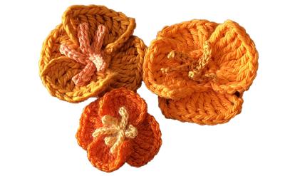crochet poppies made with bright orange yarn