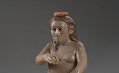 a ceramic sculpture of an un-idealized nude woman