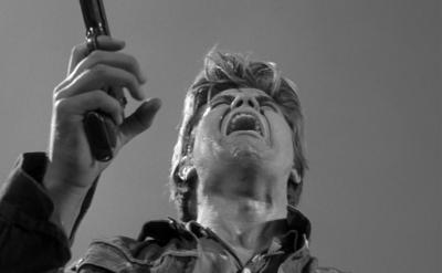 a man screams while holding gun