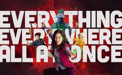 Woman in front of white text with the words Everything everywhere all at once red background
