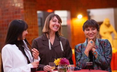 three women smiling during an outdoor event