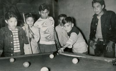 students relaxing by paying pool