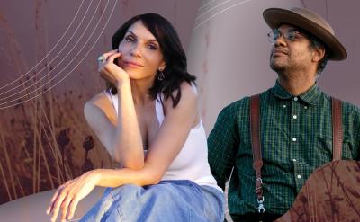 A woman in a white top and blue jeans sits, resting her chin on her hand, while a man wearing a hat, glasses, green plaid shirt, and suspenders stands looking up. The background features stylized grass and abstract geometric patterns.