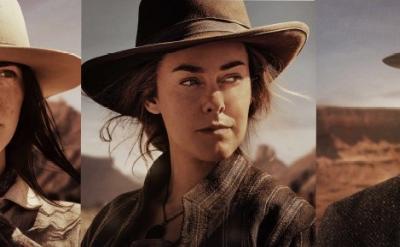 Three individuals in cowboy hats and western attire stand against a desert backdrop. Each has a serious expression, suggesting a theme of adventure or exploration in a rugged, outdoor setting.