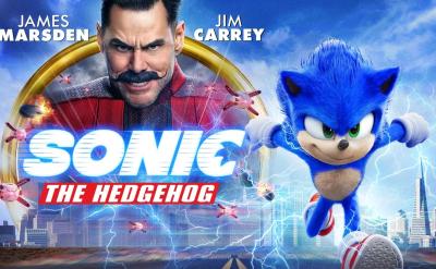 Poster for the "Sonic the Hedgehog" movie featuring Sonic running with a determined expression. Jim Carrey and James Marsden's names are visible, along with Carrey's character in a red suit and sunglasses. Sonic is surrounded by lightning and a cityscape.