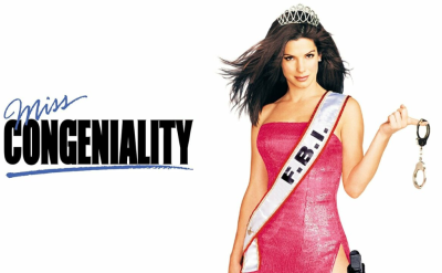 A woman in a pink dress and tiara poses with handcuffs and a "F.B.I." sash. Beside her, bold text reads "Miss Congeniality" with "Miss" in script above "Congeniality." The background is white.