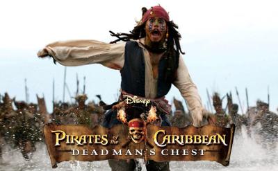 A pirate in a red bandana and colorful face paint runs frantically on a beach, pursued by a large group of armed islanders. “Pirates of the Caribbean: Dead Man’s Chest” logo is displayed at the bottom.