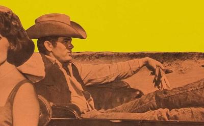 Three people sit in a convertible car against a yellow background; one man reclines with his legs up, a woman looks forward, and another man sits beside her. An oil derrick is visible in the background.