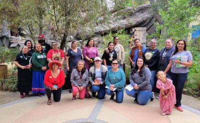 group of people posed for a photo in a garden