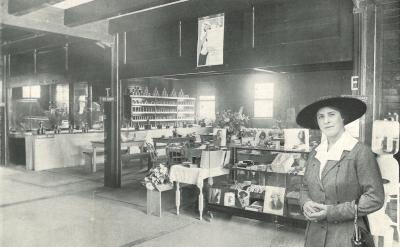 woman stands in front of shop