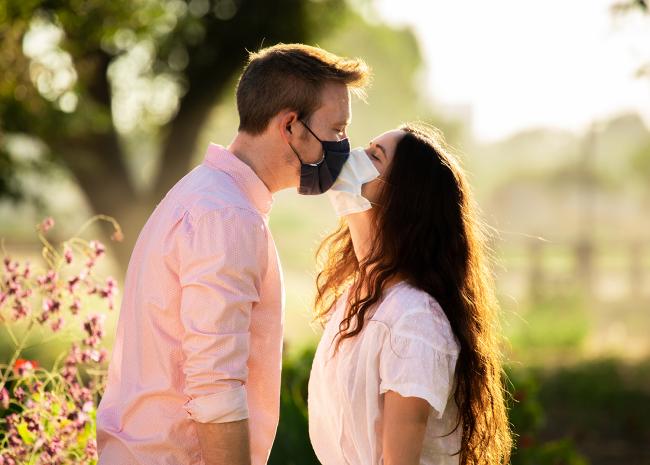couple in masks kissing