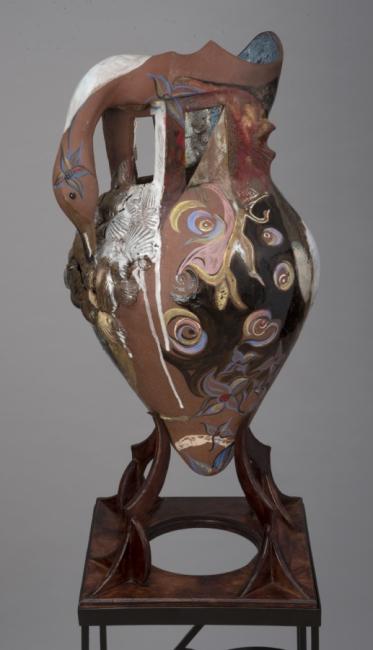 a ceramic sculpture of a vessel like shape with a goose head