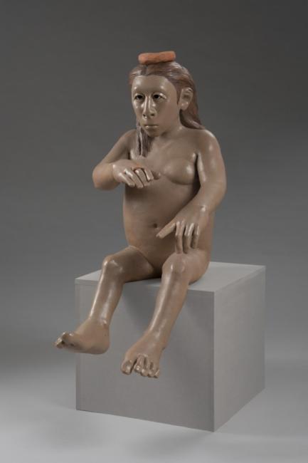 a ceramic sculpture of an un-idealized nude woman