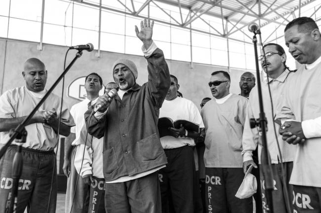 male prisoners sing on stage