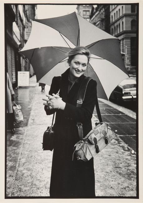 meryl streep on street with umbrella