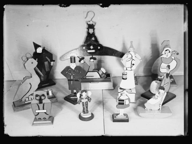 a group of wooden figurines one is a clothes hanger