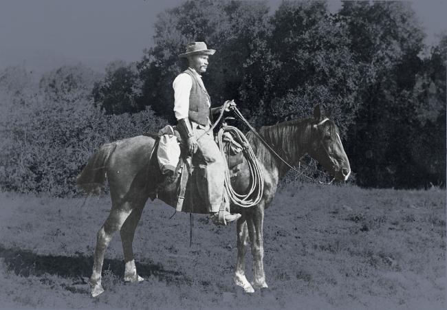 Vintage image of black cowboy on horse 