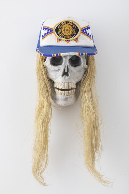 a skull with a wig and hat