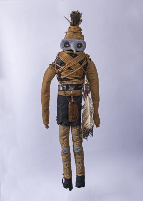 a doll in native american garb and a long nose