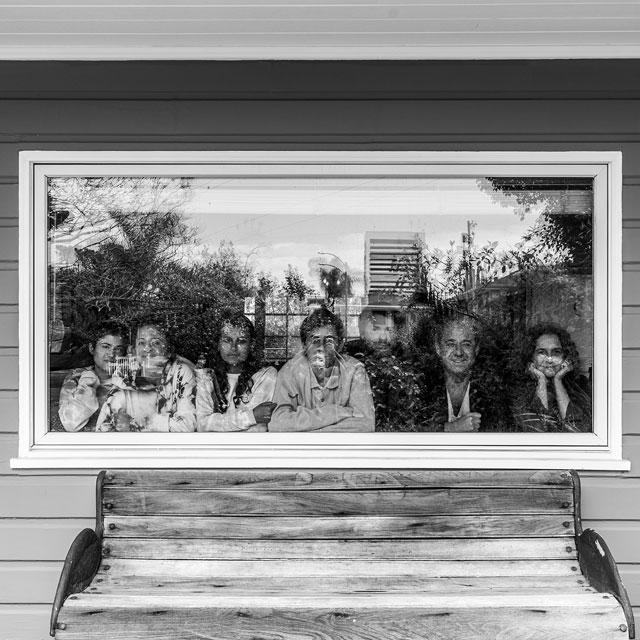 Family in window sheltering in place