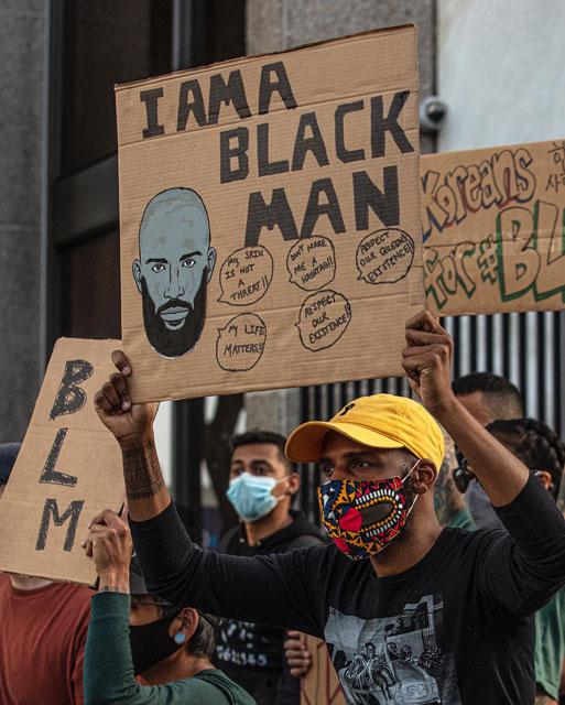 man holding protest sign
