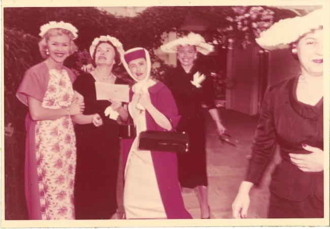group of women dressed for a luncheon wearing fancy hats