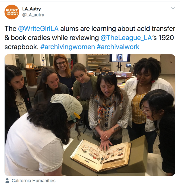 students around librarian who discusses archival materials