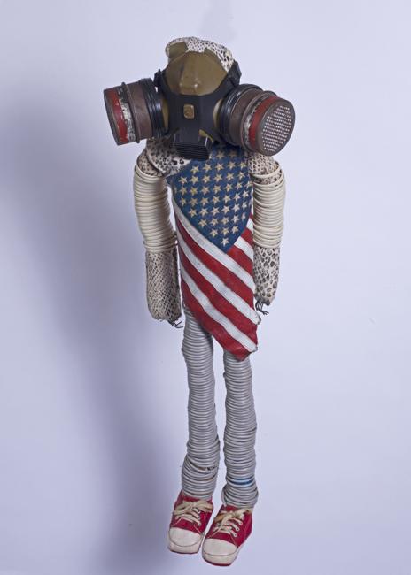 a doll wearing a gas mask and an american flag