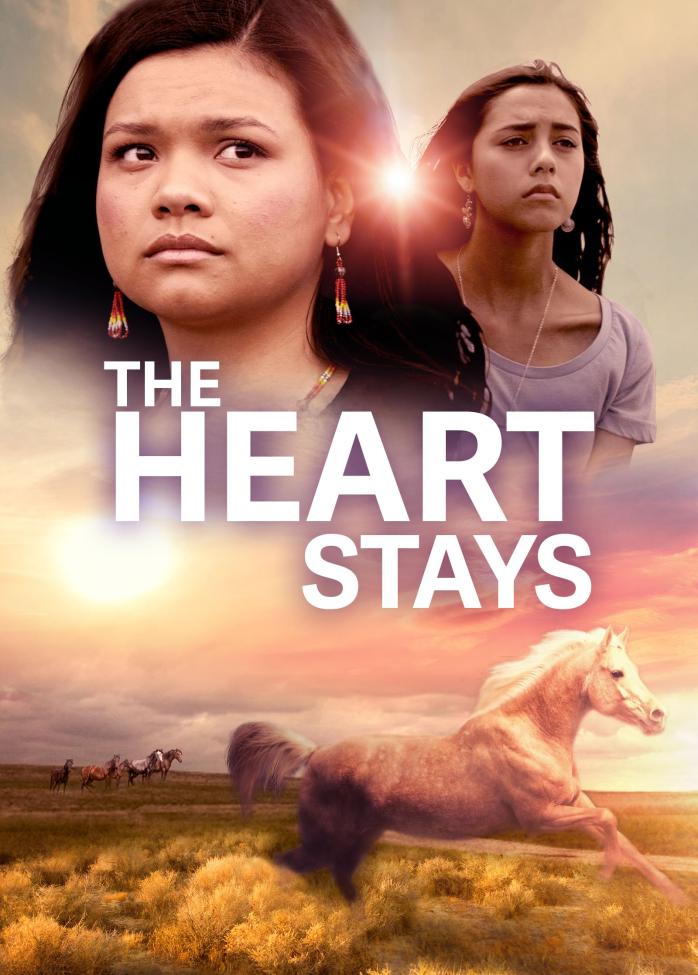 Two women with serious expressions appear above the title "The Heart Stays" in bold white letters. Below them, a horse runs on a grassy plain during sunset, with a herd of horses in the distance.