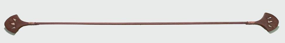 A long, wooden staff with flat, paddle-like ends, each carved with geometric cutouts. The staff is reddish-brown and symmetrical, with a slightly tapered central shaft.