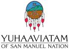 Logo of the Yuhaaviatam of San Manuel Nation featuring a circular emblem with arrows, mountain, and feathers, above the text "YUHAAVIATAM OF SAN MANUEL NATION.