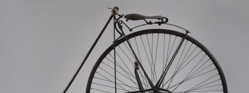 top half of a bicycle wheel, with the seat and handle bars attached above it