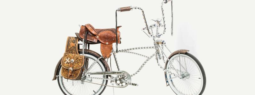 A bicycle made largely of chains with a horse saddle for a seat