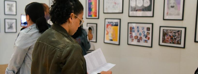 individuals standing in front of art work