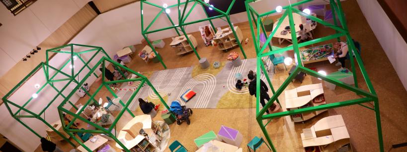 aerial perspective of the family play space with toys, tables, chairs, and activities for children and families